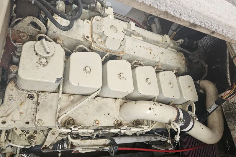 Slide: The Image of Engine compartment of a 1998 Nordic Tug 32, showcasing mechanical components and piping. - 46