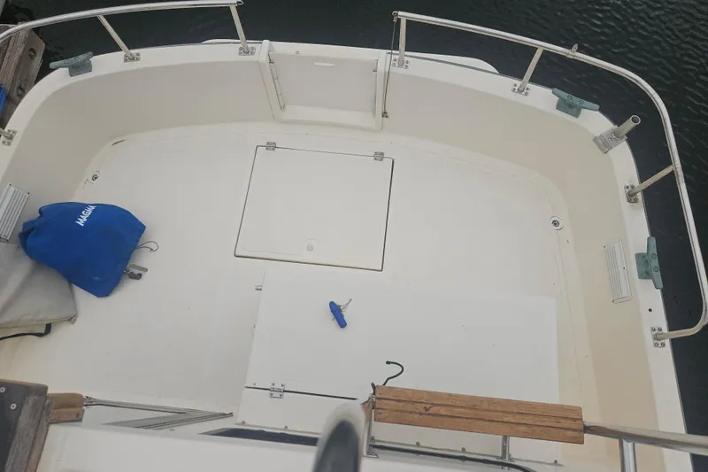 Slide: The Image of Cockpit of a 1998 Nordic Tug 32 boat with railing and storage compartments. - 5