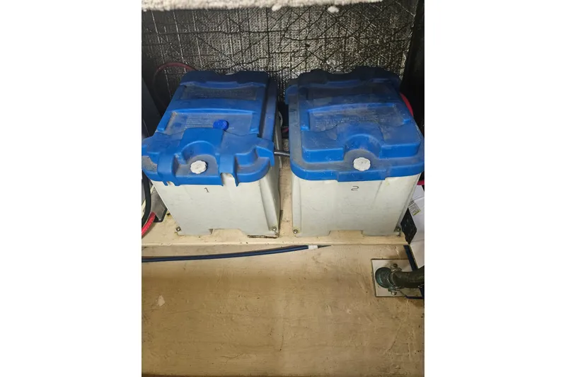 Slide: The Image of Two marine batteries in a 1998 Nordic Tug 32 engine compartment. - 52