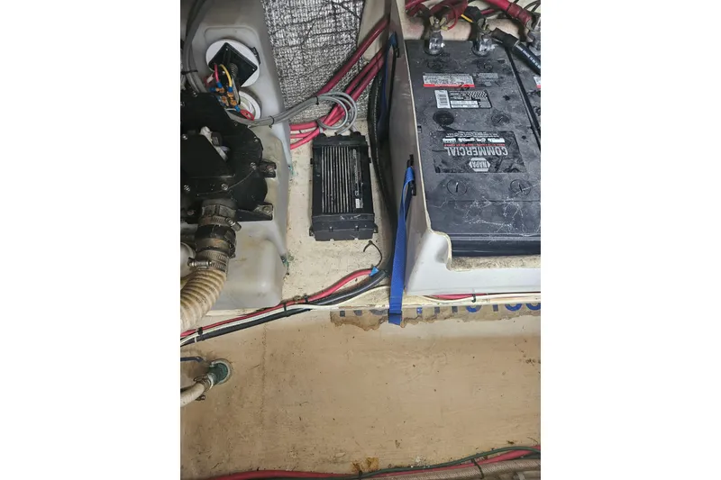 Slide: The Image of Engine compartment of a 1998 Nordic Tug 32, featuring battery and wiring components. - 54