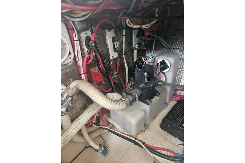 Slide: The Image of Engine compartment of a 1998 Nordic Tug 32 with visible wiring and components. - 55