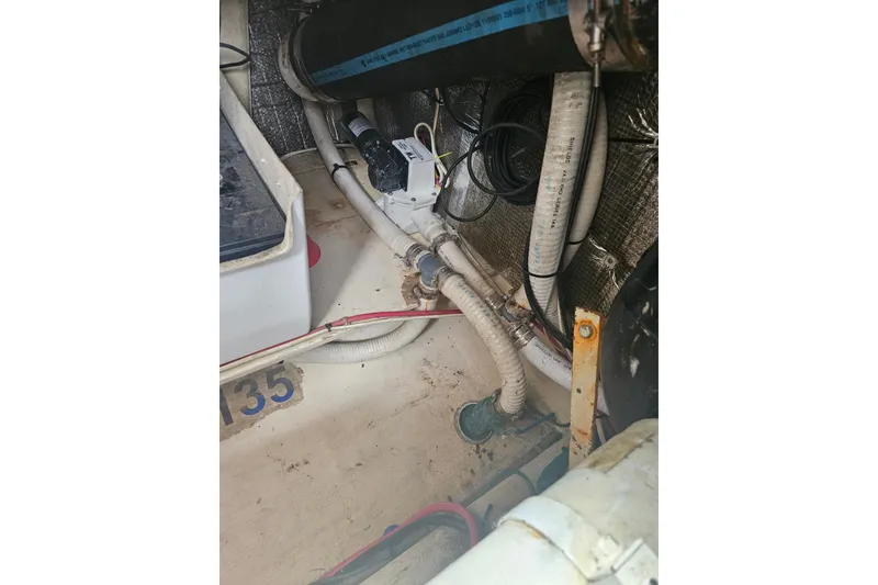 Slide: The Image of Engine compartment of a 1998 Nordic Tug 32, showing hoses and wiring. - 57