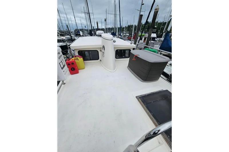 Slide: The Image of 1998 Nordic Tug 32 boat deck with storage and fuel containers at marina. - 9