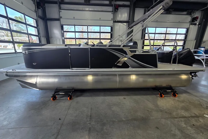 Slide: The Image of 2026 Avalon LSZ 2185 Cruise Rear Bench pontoon boat in a showroom. - 2