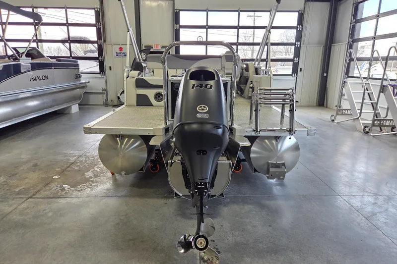 Slide: The Image of 2026 Avalon LSZ 2185 Cruise Rear Bench pontoon boat in showroom, featuring powerful outboard motor. - 3