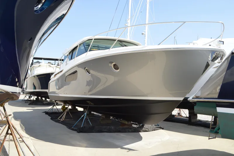 The Image of 2017 Tiara Yachts C44 Coupe on display at a marina, side view. - 0
