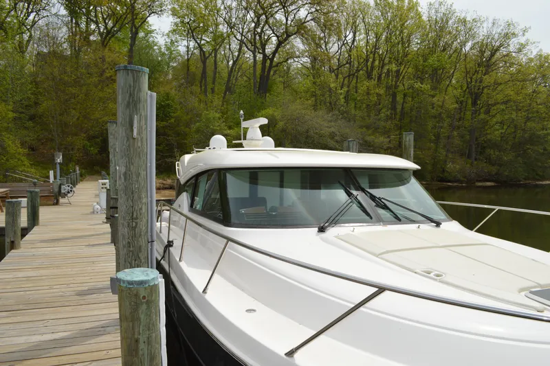 Slide: The Image of 2017 Tiara Yachts C44 Coupe docked at a serene pier. - 11