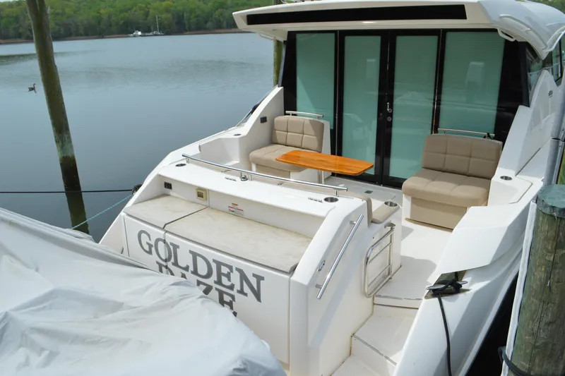 Slide: The Image of 2017 Tiara Yachts C44 Coupe at dock with seating area. - 14