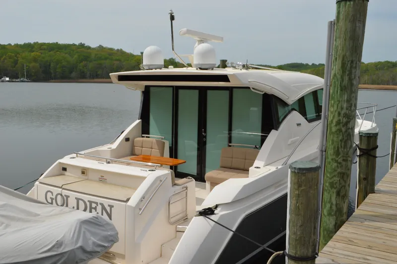 Slide: The Image of 2017 Tiara Yachts C44 Coupe docked, serene water backdrop. - 15