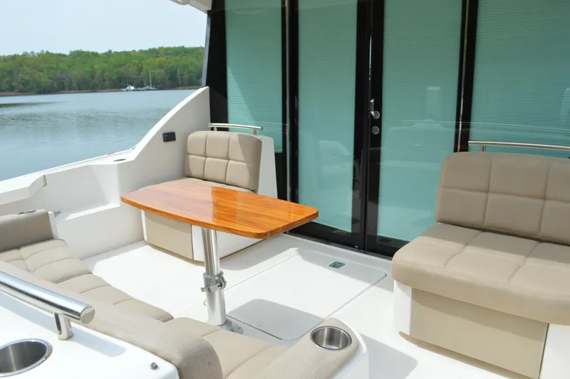 Slide: The Image of 2017 Tiara Yachts C44 Coupe, elegant outdoor seating area with table. - 19