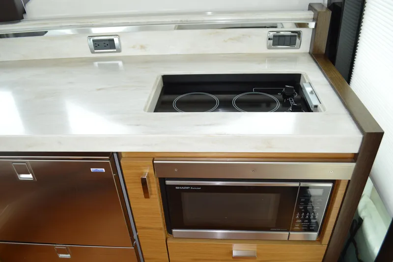 Slide: The Image of Tiara Yachts C44 Coupe 2017 kitchen area with stove and microwave. - 31