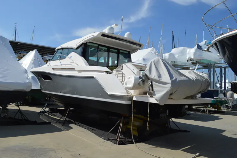 Slide: The Image of 2017 Tiara Yachts C44 Coupe in dry dock, covered and ready for maintenance. - 4