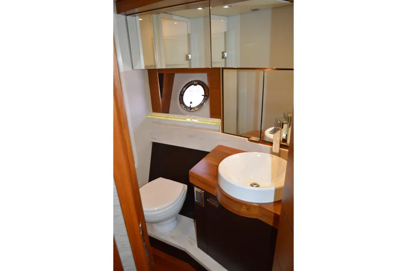 Slide: The Image of Luxurious bathroom in 2017 Tiara Yachts C44 Coupe with modern fixtures and porthole window. - 44