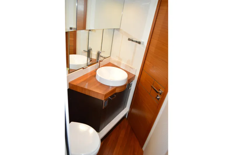 Slide: The Image of Luxurious bathroom in 2017 Tiara Yachts C44 Coupe with modern sink and wooden accents. - 48