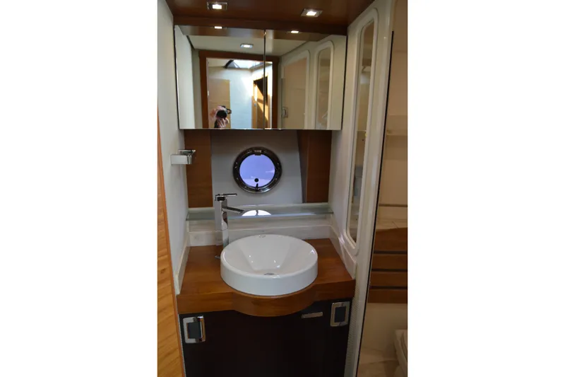 Slide: The Image of Luxurious bathroom interior of 2017 Tiara Yachts C44 Coupe with modern fixtures and porthole. - 49