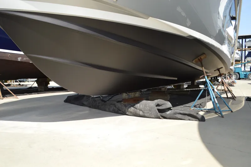 Slide: The Image of 2017 Tiara Yachts C44 Coupe hull on dry dock, supported by stands. - 5
