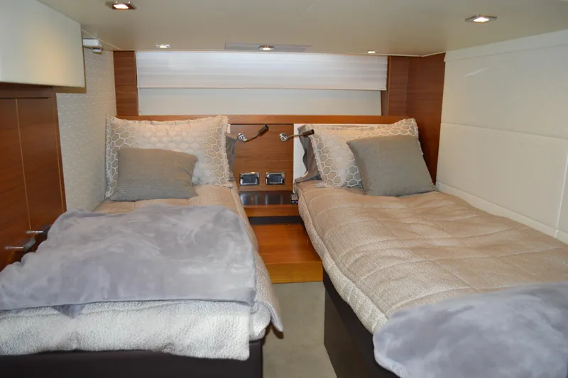 Slide: The Image of Luxurious twin beds in 2017 Tiara Yachts C44 Coupe cabin interior. - 52