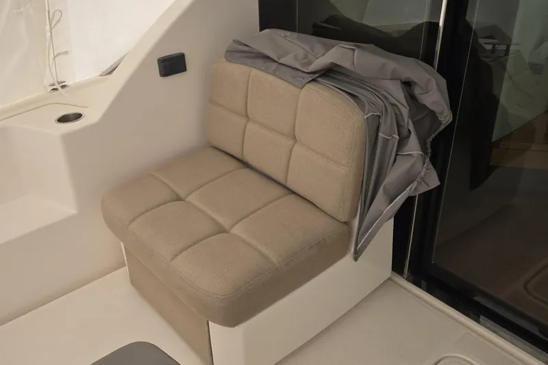 Slide: The Image of Beige cushioned seat on 2017 Tiara Yachts C44 Coupe, with folded cover. - 53