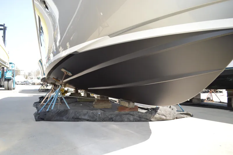 Slide: The Image of 2017 Tiara Yachts C44 Coupe hull on dry dock, showcasing sleek design and craftsmanship. - 6