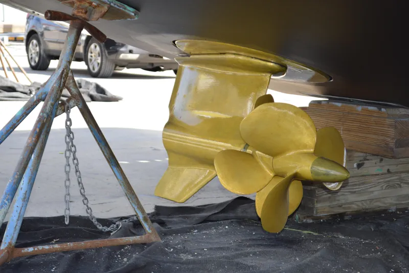 Slide: The Image of Propeller of 2017 Tiara Yachts C44 Coupe on dry dock, supported by metal stand. - 7