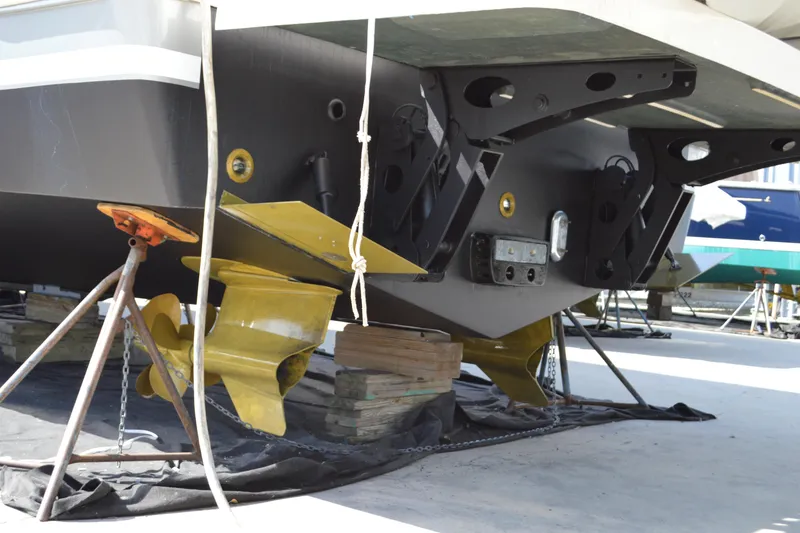 Slide: The Image of 2017 Tiara Yachts C44 Coupe under maintenance, showcasing propellers and hull details. - 9