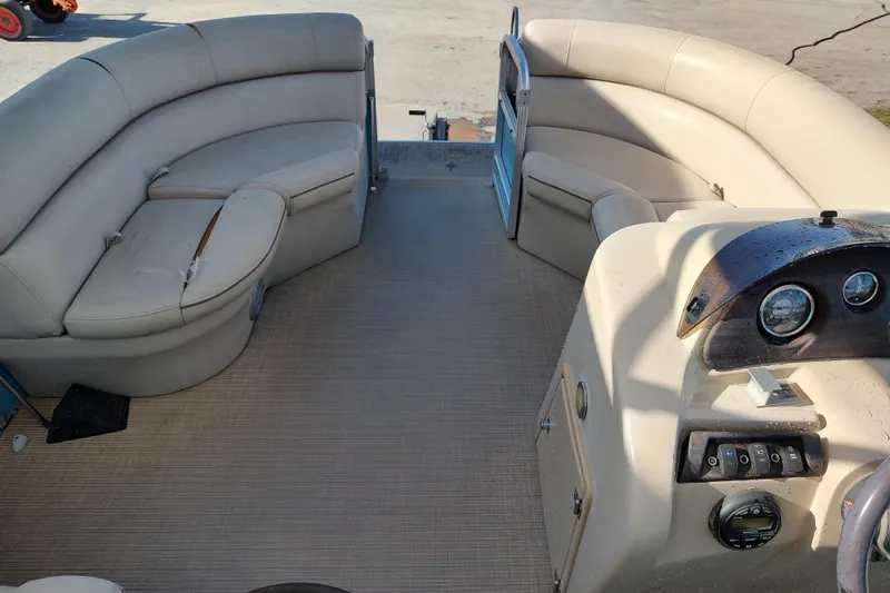 Slide: The Image of 2019 South Bay S222FCR pontoon boat interior with beige seating and control panel. - 10