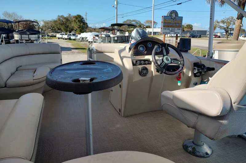 Slide: The Image of 2019 South Bay S222FCR pontoon boat interior with steering console and seating area. - 14