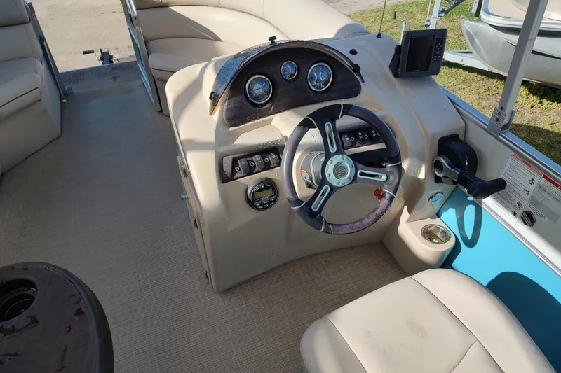Slide: The Image of 2019 South Bay S222FCR boat interior with steering wheel and control panel. - 15