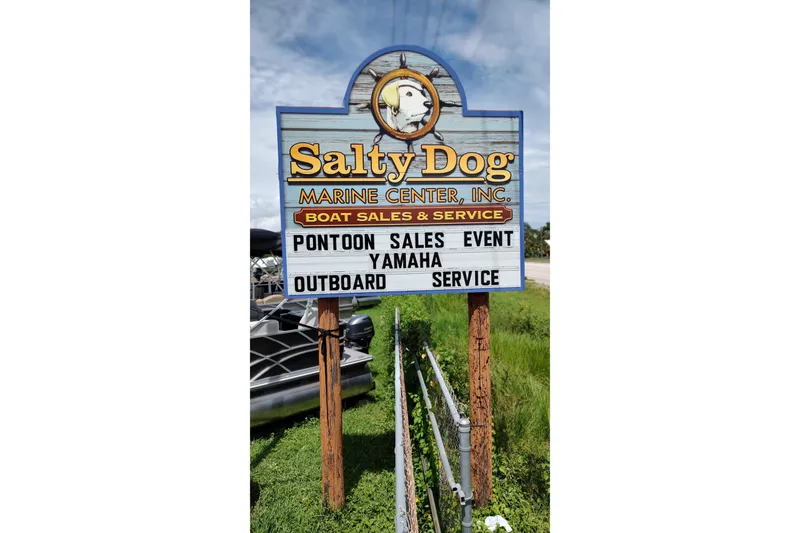 Slide: The Image of Salty Dog Marine Center sign promoting pontoon sales and Yamaha outboard service, featuring South Bay S222FCR. - 17