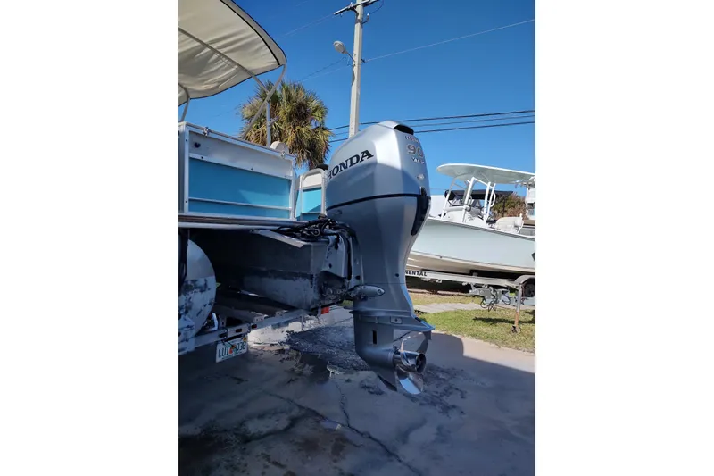 Slide: The Image of 2019 South Bay S222FCR boat with Honda outboard motor in a sunny outdoor setting. - 3