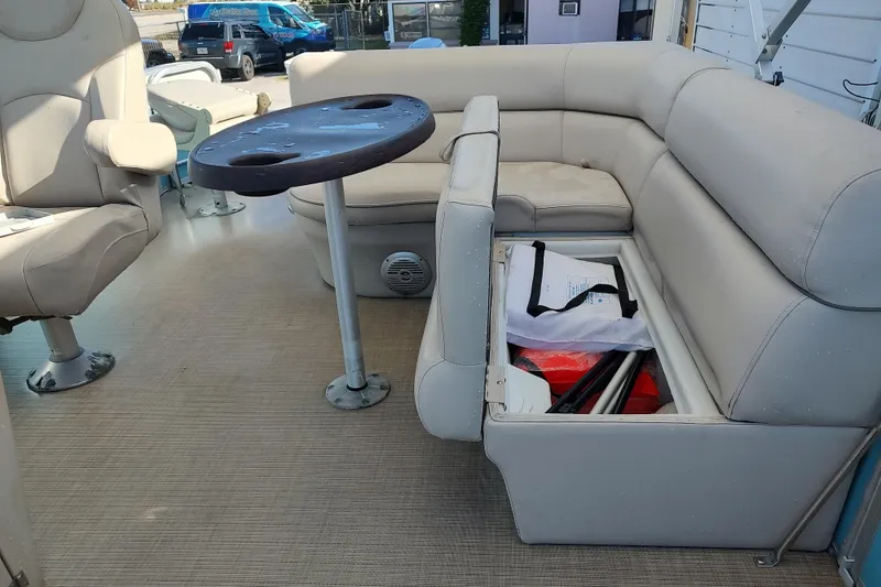 Slide: The Image of 2019 South Bay S222FCR pontoon boat interior with seating and storage compartment. - 5