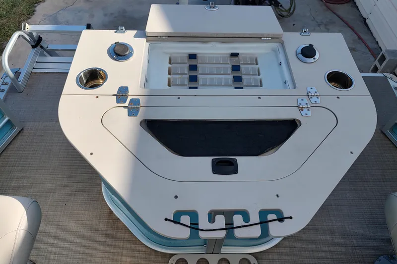 Slide: The Image of 2019 South Bay S222FCR boat deck with storage compartments and cup holders. - 7