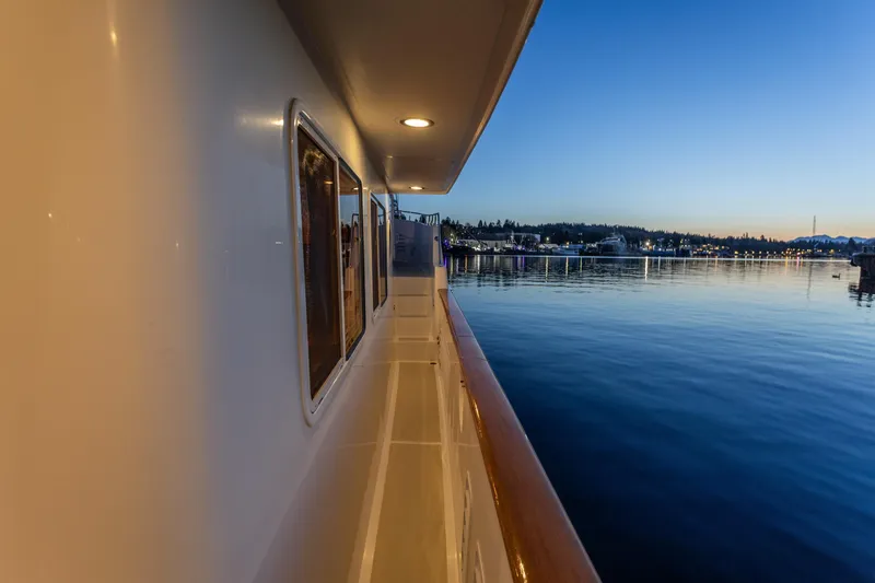 Slide: The Image of Side view of 2003 Selene 47 yacht at sunset, overlooking calm waters and distant shoreline. - 15