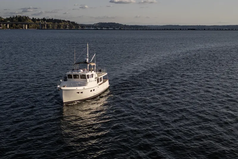Slide: The Image of Selene 47 yacht from 2003 cruising on a calm lake with distant bridge view. - 5