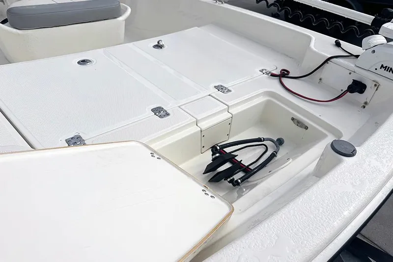 Slide: The Image of 2020 Mako Pro Skiff 15 CC boat interior with storage compartments and wiring. - 12