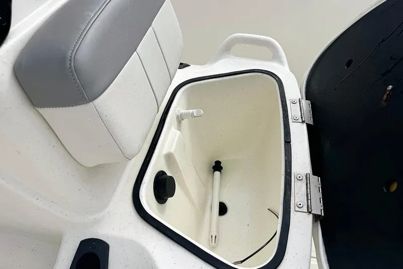 Slide: The Image of Open storage compartment in 2020 Mako Pro Skiff 15 CC boat, featuring cushioned seating. - 14