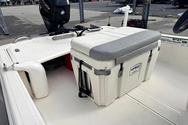 Slide: The Image of 2020 Mako Pro Skiff 15 CC boat interior with cooler seat and Mercury engine. - 17