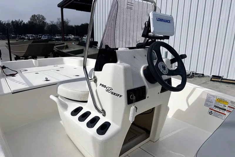Slide: The Image of 2020 Mako Pro Skiff 15 CC boat interior with steering wheel and Lowrance device. - 19
