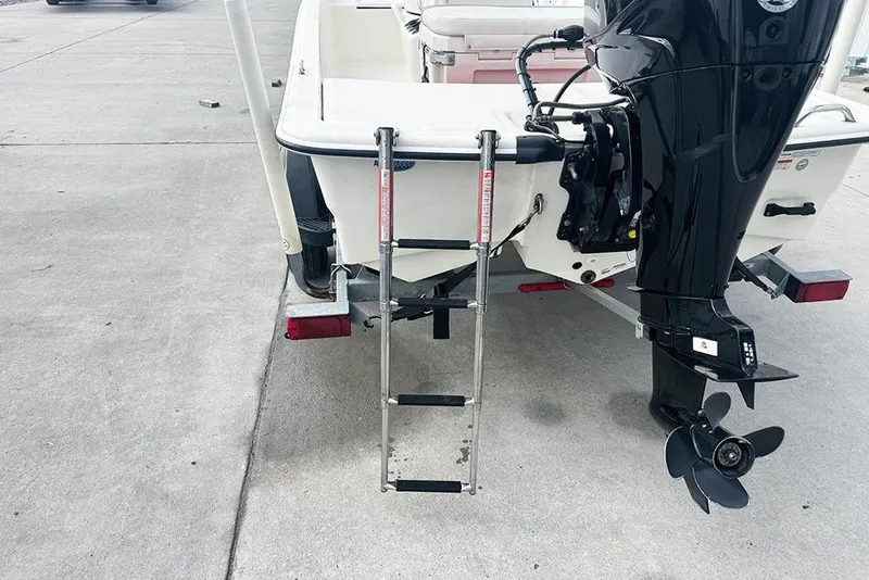 Slide: The Image of 2020 Mako Pro Skiff 15 CC boat with ladder and outboard motor on trailer. - 4