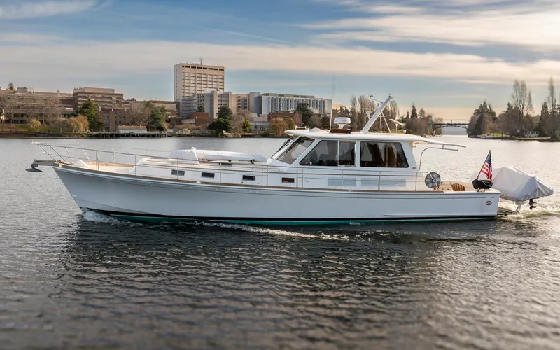 Slide: The Image of 2003 Grand Banks 54 Eastbay SX yacht on calm water. - 2