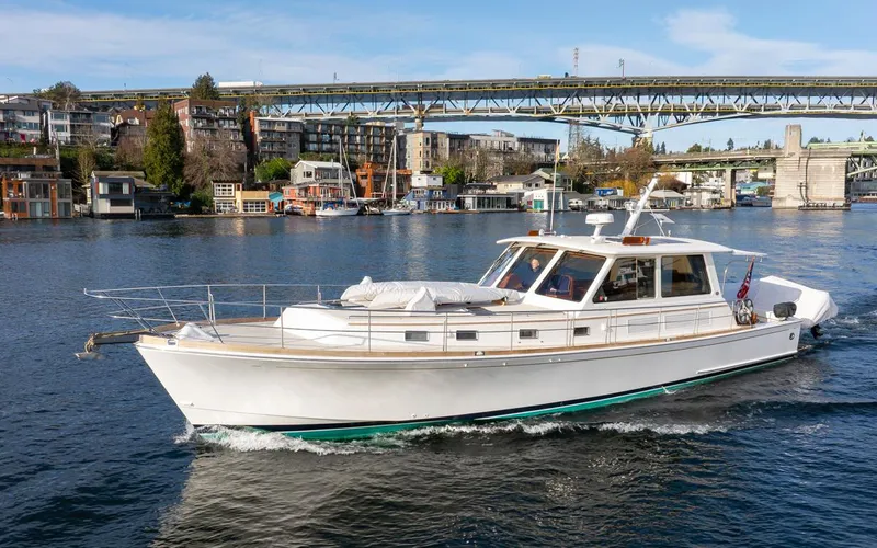 Slide: The Image of 2003 Grand Banks 54 Eastbay SX yacht on a river. - 45