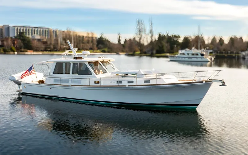 Slide: The Image of 2003 Grand Banks 54 Eastbay SX yacht on calm water. - 48