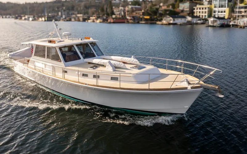 Slide: The Image of 2003 Grand Banks 54 Eastbay SX cruising on a calm lake. - 5