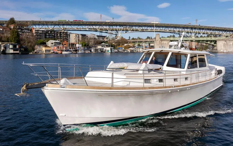 Slide: The Image of 2003 Grand Banks 54 Eastbay SX yacht cruising on a river. - 6