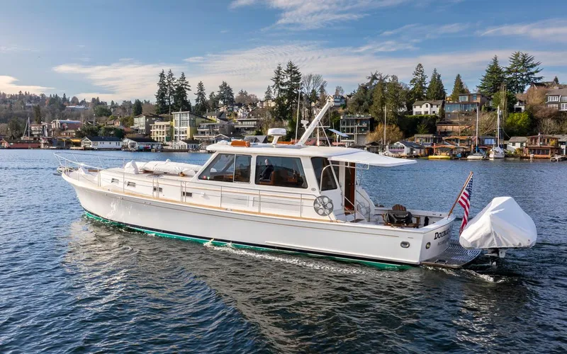 Slide: The Image of 2003 Grand Banks 54 Eastbay SX yacht on calm water. - 8