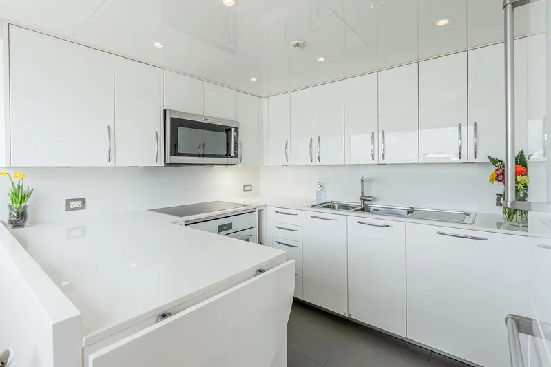 Slide: The Image of Modern white kitchen on 2017 Sanlorenzo SD112 yacht, featuring sleek cabinets and stainless steel appliances. - 39