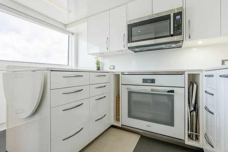 Slide: The Image of Modern kitchen in 2017 Sanlorenzo SD112 yacht with sleek white cabinetry and built-in appliances. - 41