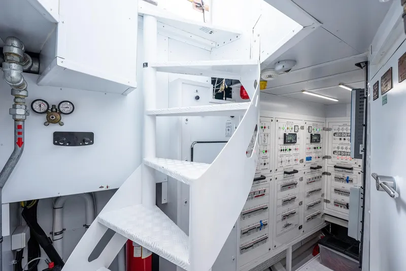 Slide: The Image of Engine room of 2017 Sanlorenzo SD112 yacht with control panels and white staircase. - 47