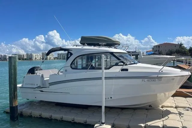 The Image of 2023 Beneteau Antares 8 boat docked on a sunny day, with clear blue skies. - 1
