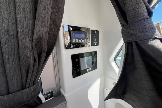 Slide: The Image of Interior of 2023 Beneteau Antares 8 with control panel and curtains. - 13